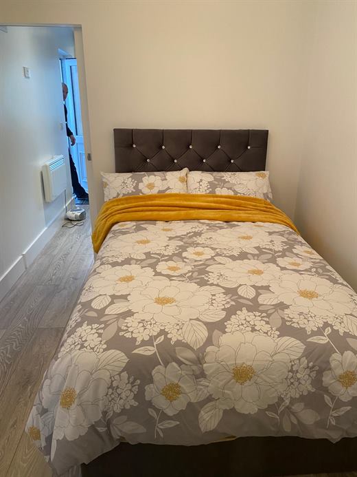 Bedroom with upholstered bed and painted walls