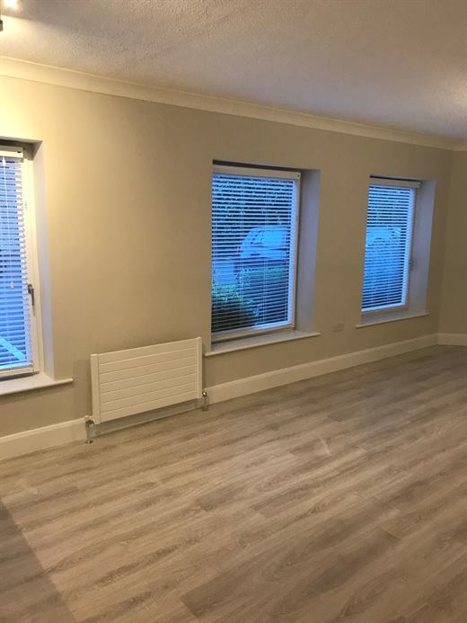 Bright room with new windows and laminate flooring