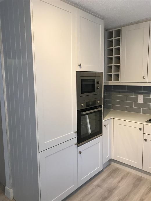 Cream shaker kitchen with built-in oven, microwave and wine rack
