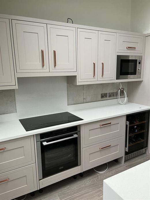 Cream shaker kitchen with copper handles, induction hob and oven