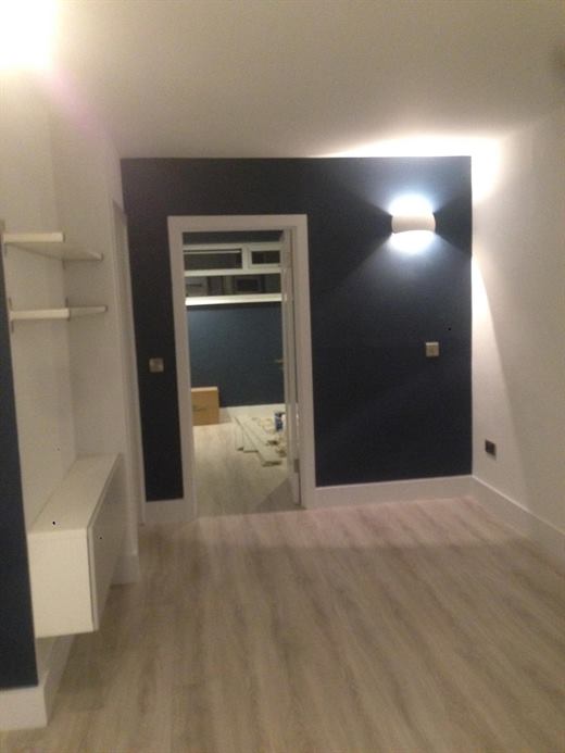 Hallway with navy feature wall and wall light