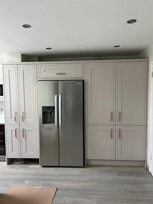 Kitchen with tall fridge freezer housing and laminate floor
