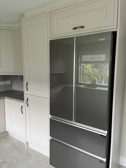 Kitchen with tall unit housing a French-door fridge freezer