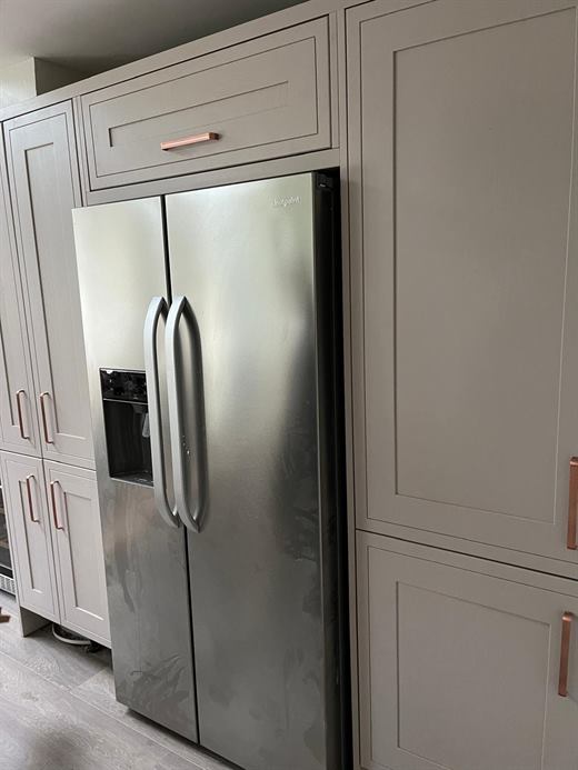Kitchen with tall units housing an American fridge freezer