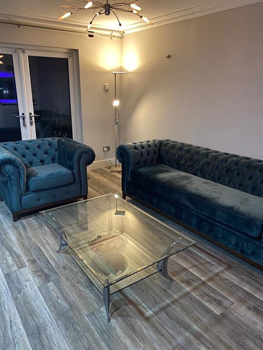 Living room with navy sofas and glass coffee table