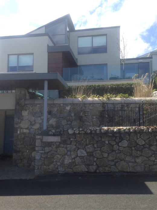 Modern house with terraces and stone boundary wall