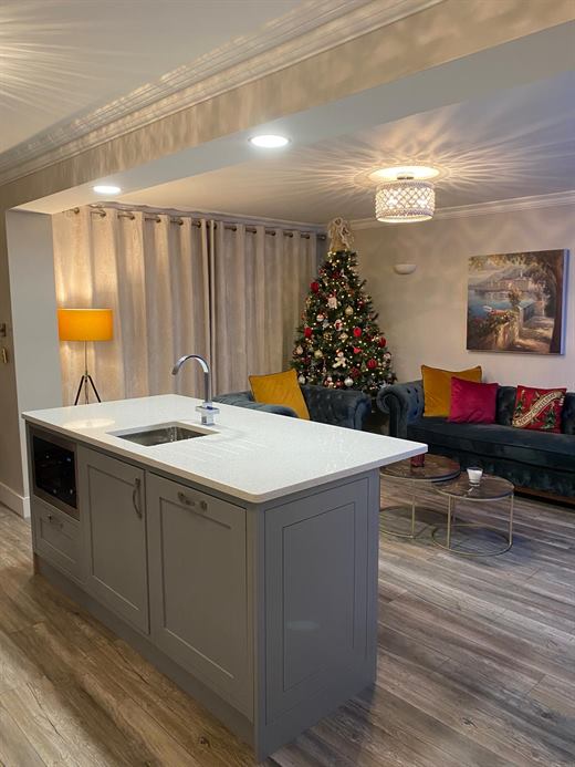 Open-plan kitchen island looking onto the living room