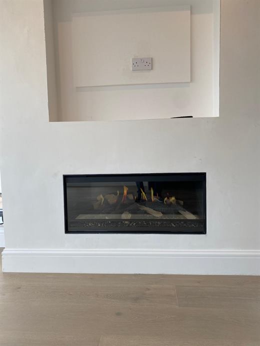 Recessed gas fire in a plastered chimney breast