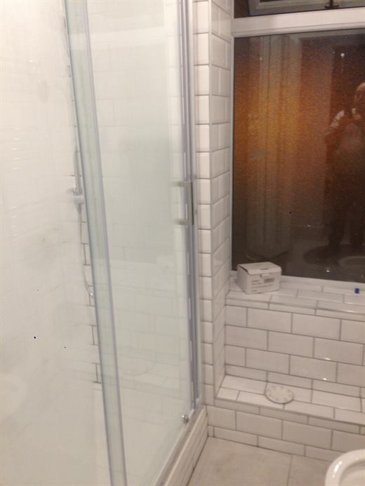 Shower enclosure with white metro tiles