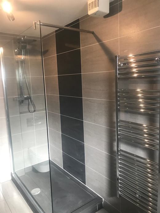 Shower with glass screen and chrome towel radiator