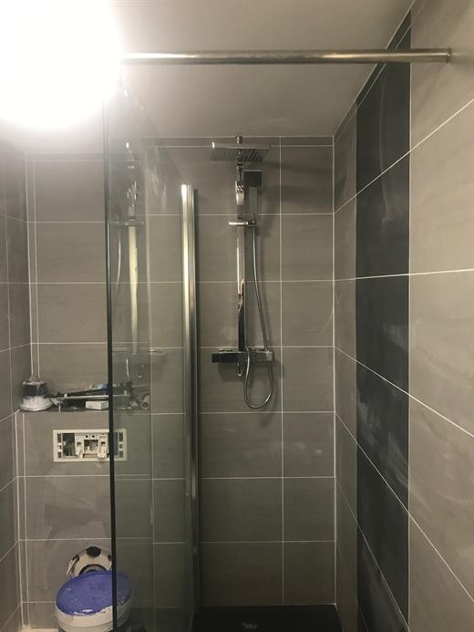 Tiled walk-in shower with glass screen