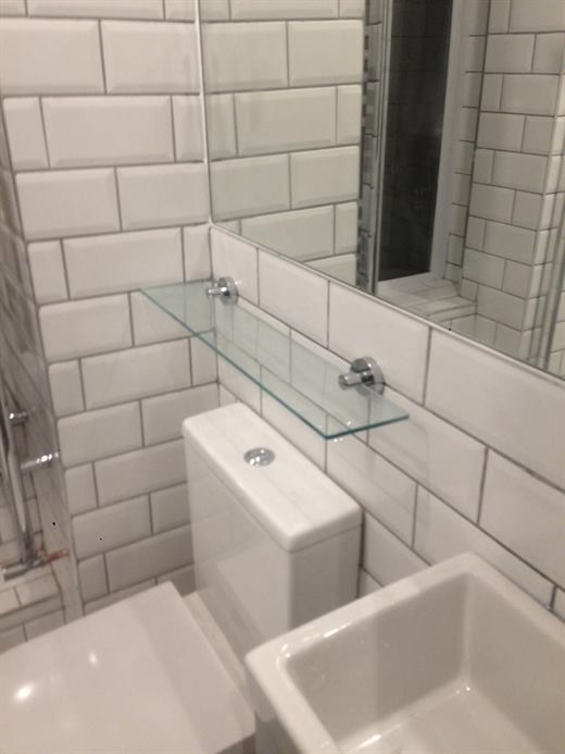 Toilet and basin with glass shelf and metro tiles