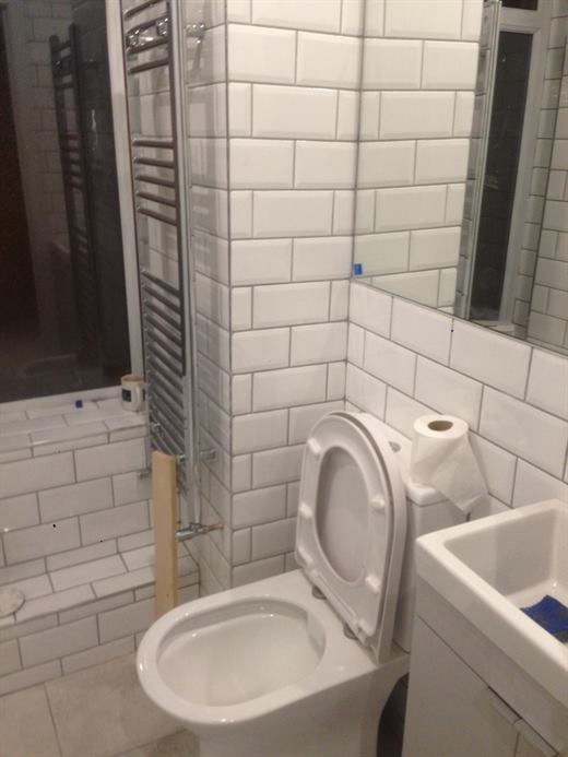 Toilet, heated towel rail and metro tiles