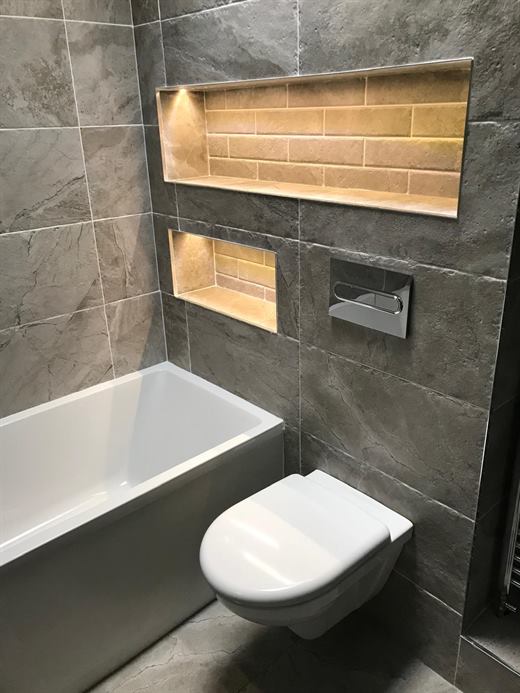 Wall-hung toilet with lit tiled niches
