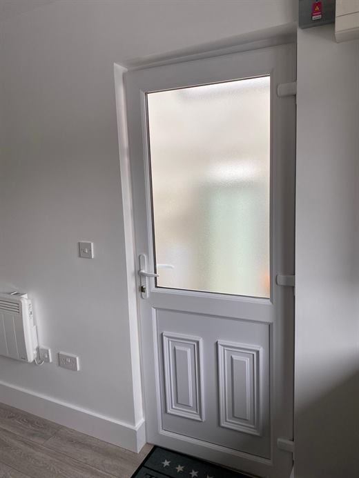 White front door with frosted glass panel